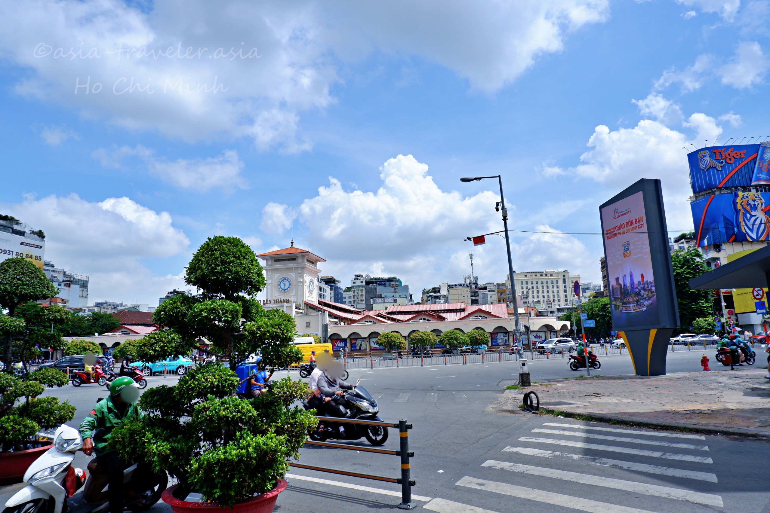 ベンタイン市場前の交差点を走るバイクと青空